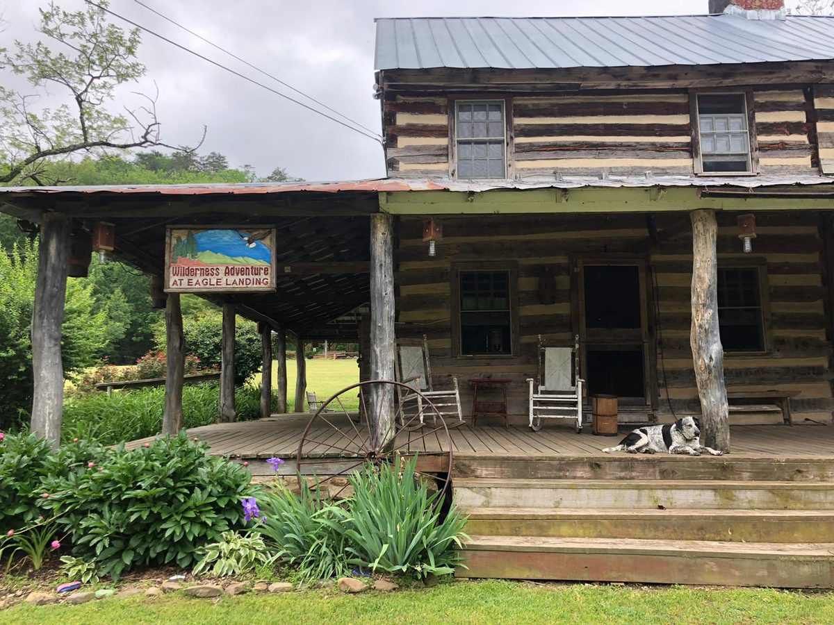 The Old Homestead log cabin and its front porch with rocking chairs