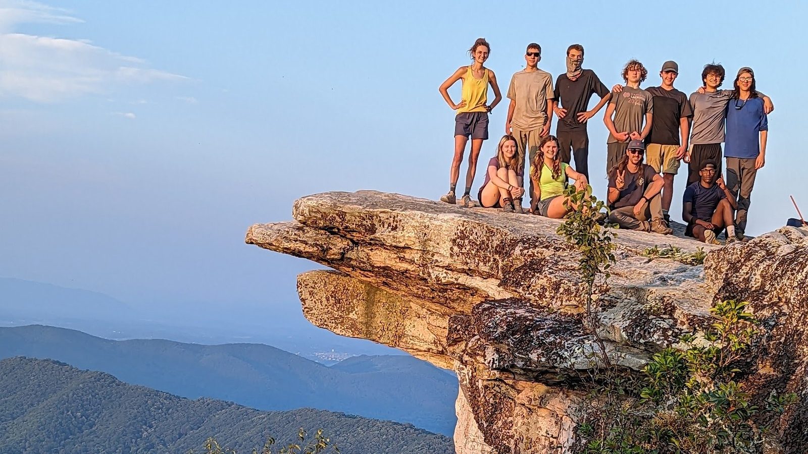 Campers and counselors together on a rocky overlook above the Blue Ridge Mountains