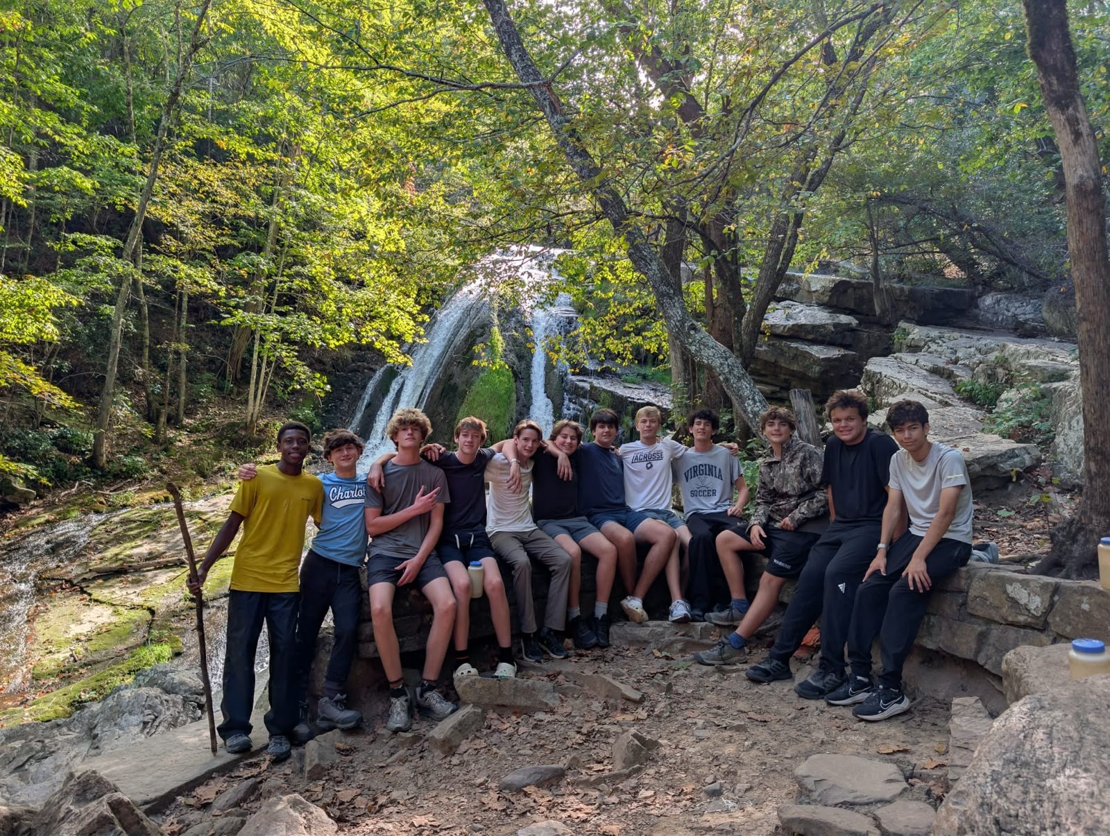 WAEL campers together beside a woodland waterfall