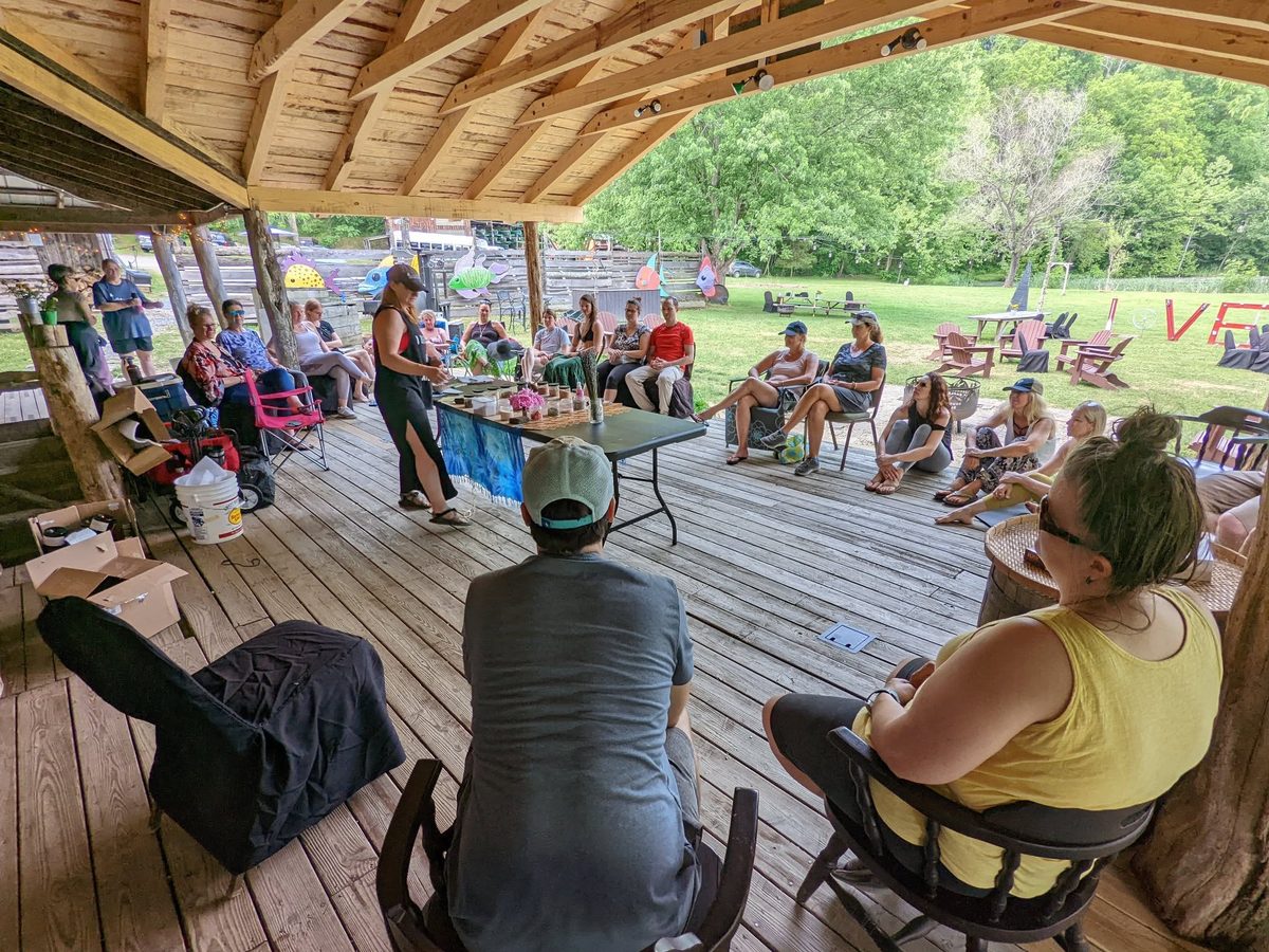 A workshop under the pavilion at Yoga Venture, guests seated in a circle