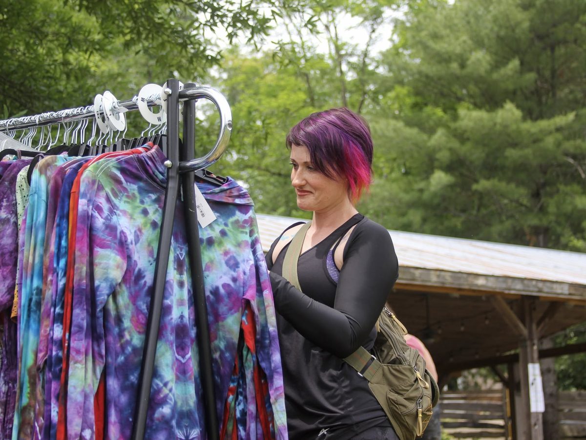 Hand-dyed clothing on a rail at the Yoga Venture vendor village